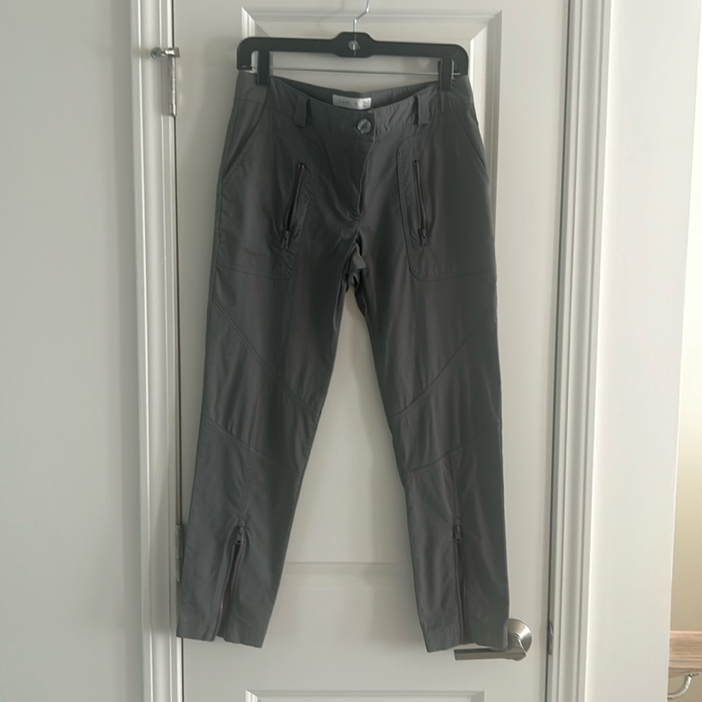 Stretch/techno material straight leg pants. Zip pockets and legs. Low rise.